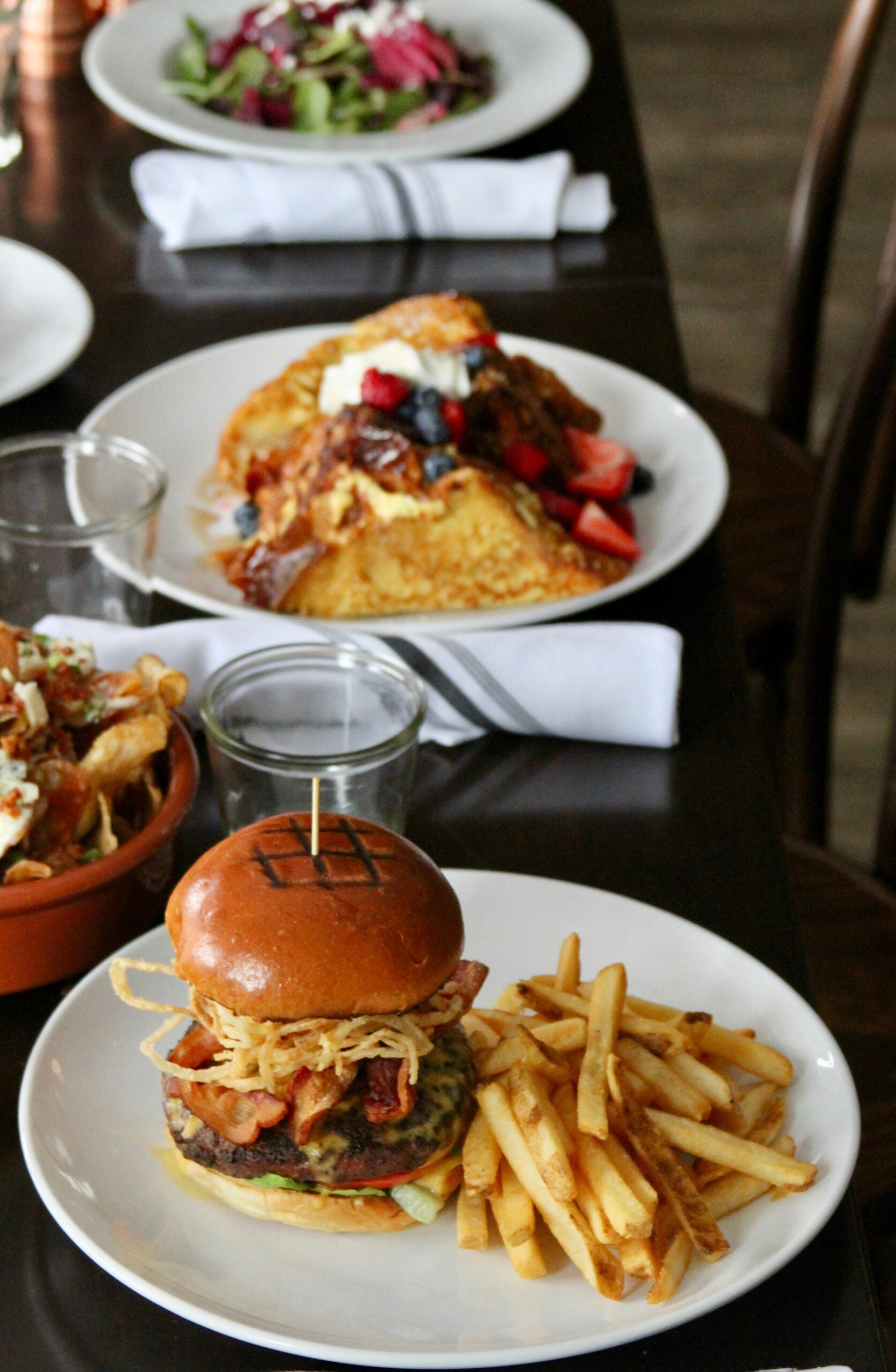 four food dishes on table in restaurant